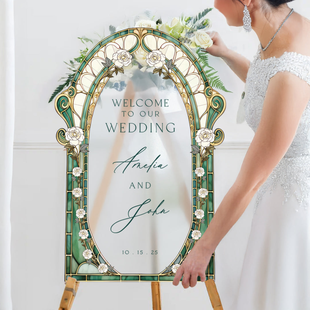 Decorative wedding sign with 'Welcome to our wedding' text, held by a person in a white dress.