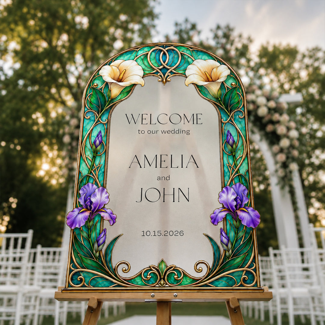 Decorative wedding sign with floral design and text on an easel outdoors.