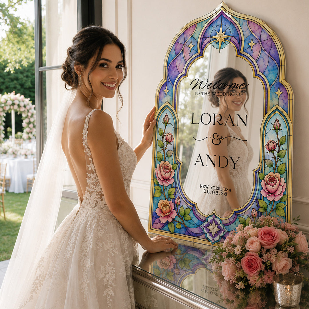 Woman in a wedding dress holding a decorative mirror with wedding details. Mughal Arch Stained Glass Peony Wedding Welcome Sign. Silver mirror wedding sign.