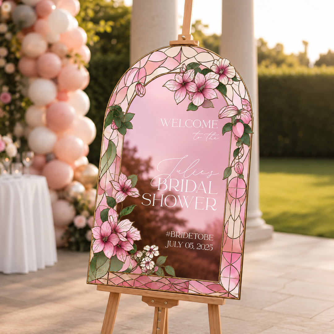 Decorative bridal shower sign with floral design and text, set outdoors with balloons.