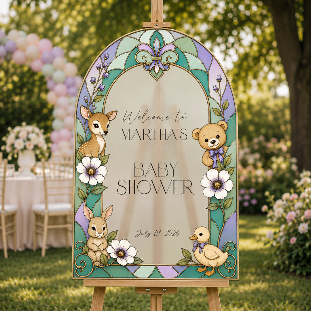 Decorative baby shower sign with animals and floral design in an outdoor setting.