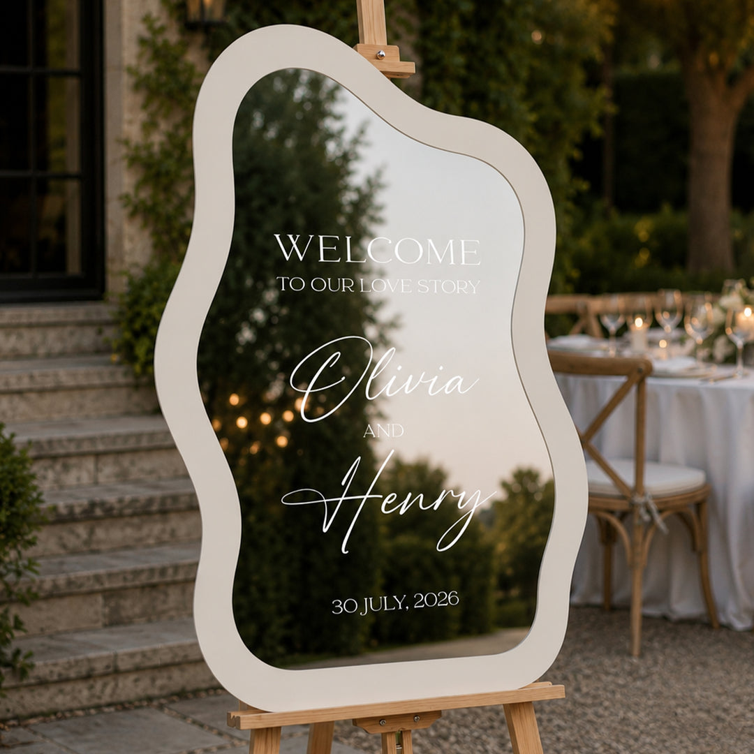Decorative mirror with wedding welcome message on an easel outdoors. Minimalist Wedding Welcome Sign — Wavy Organic Shape