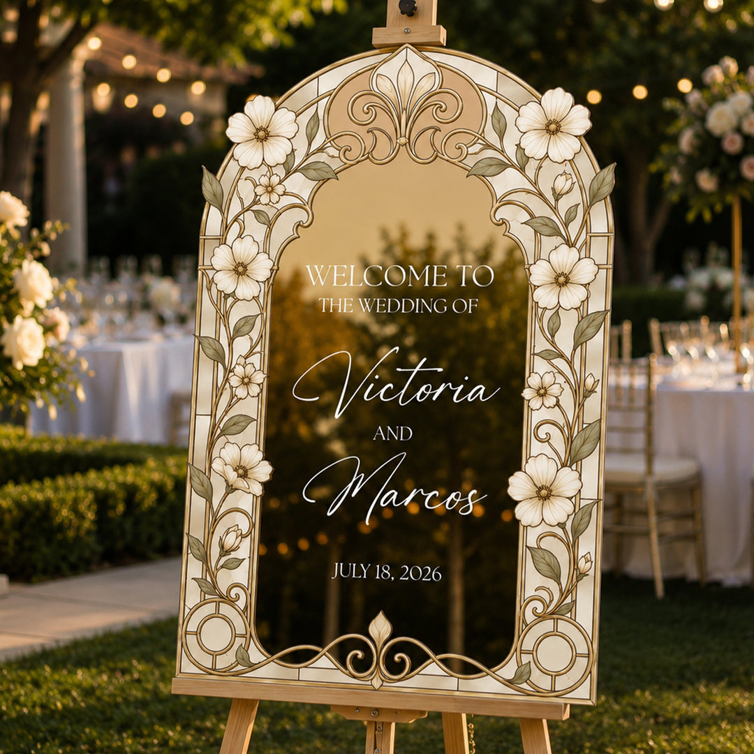 Gold botanical white daisy stained glass wedding welcome sign on easel at evening garden ceremony.
