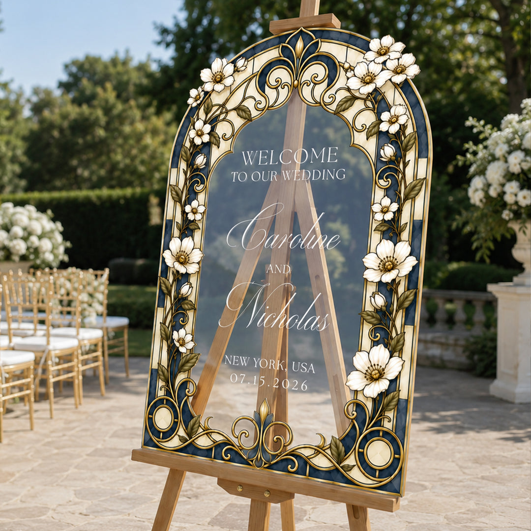 White botanical garden wedding welcome sign on easel at outdoor ceremony with couple.