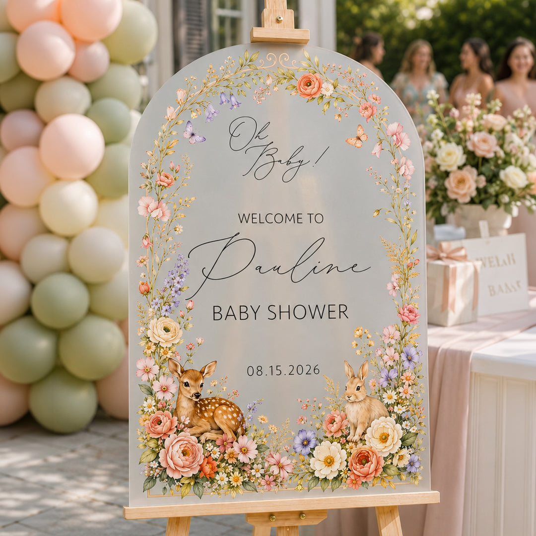 Scattered wildflower baby shower sign on frosted acrylic — soft finish with pink and orange wildflowers.