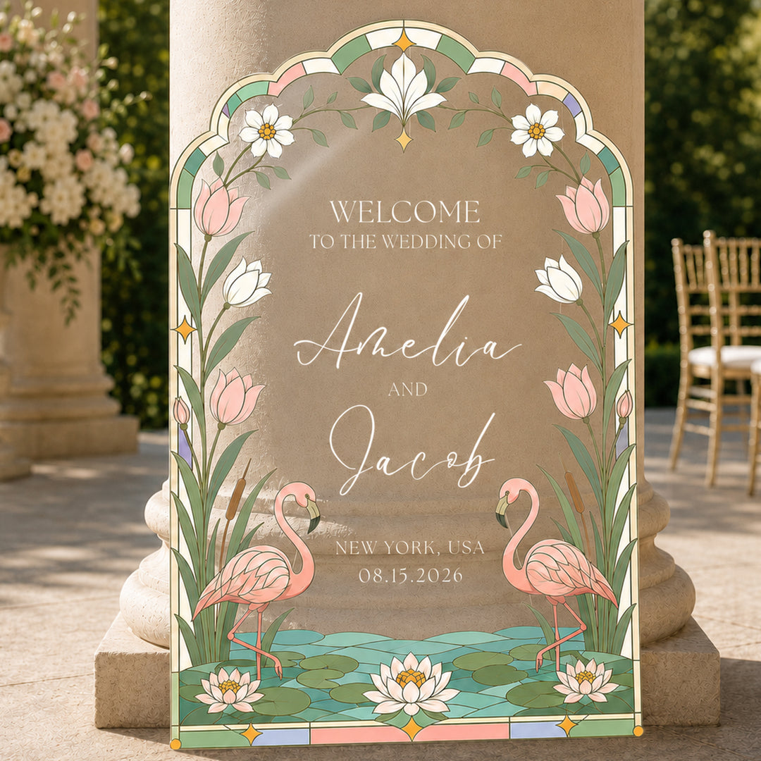 Flamingo tropical stained glass wedding welcome sign on easel at outdoor ceremony.